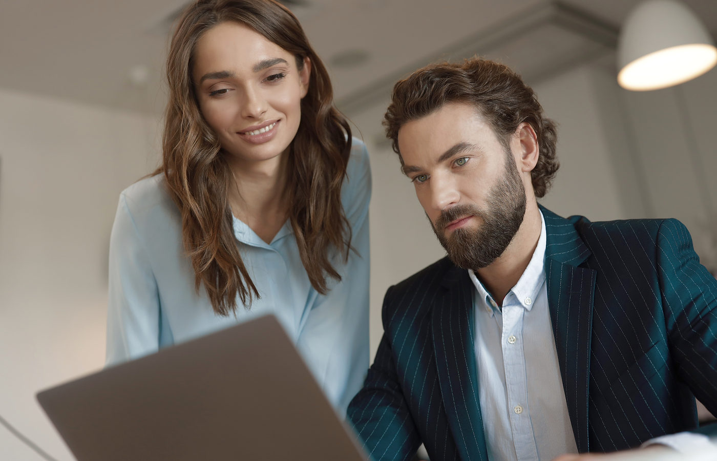 Two people reviewing technology options together on a laptop